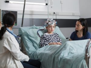 expert-pediatrician-monitoring-hospitalized-girl-brain-condition-using-eeg-headset-neurology-specialist-measuring-neurologic-disease-evolution-sick-kid-sitting-pediatric-healthcare-facility_482257-50757