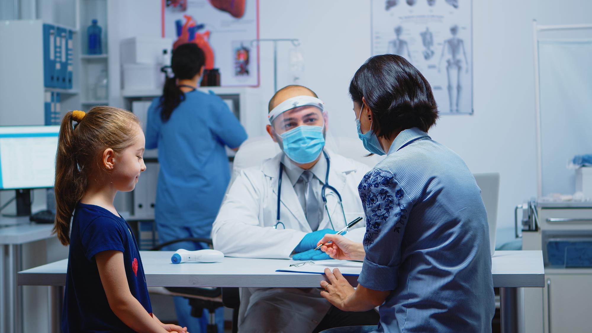 mother-writing-child-treatment-clipboard-sitting-medical-office-pediatrician-specialist-medicine-with-mask-providing-health-care-services-consultation-treatment-hospital-covid-19_482257-14518
